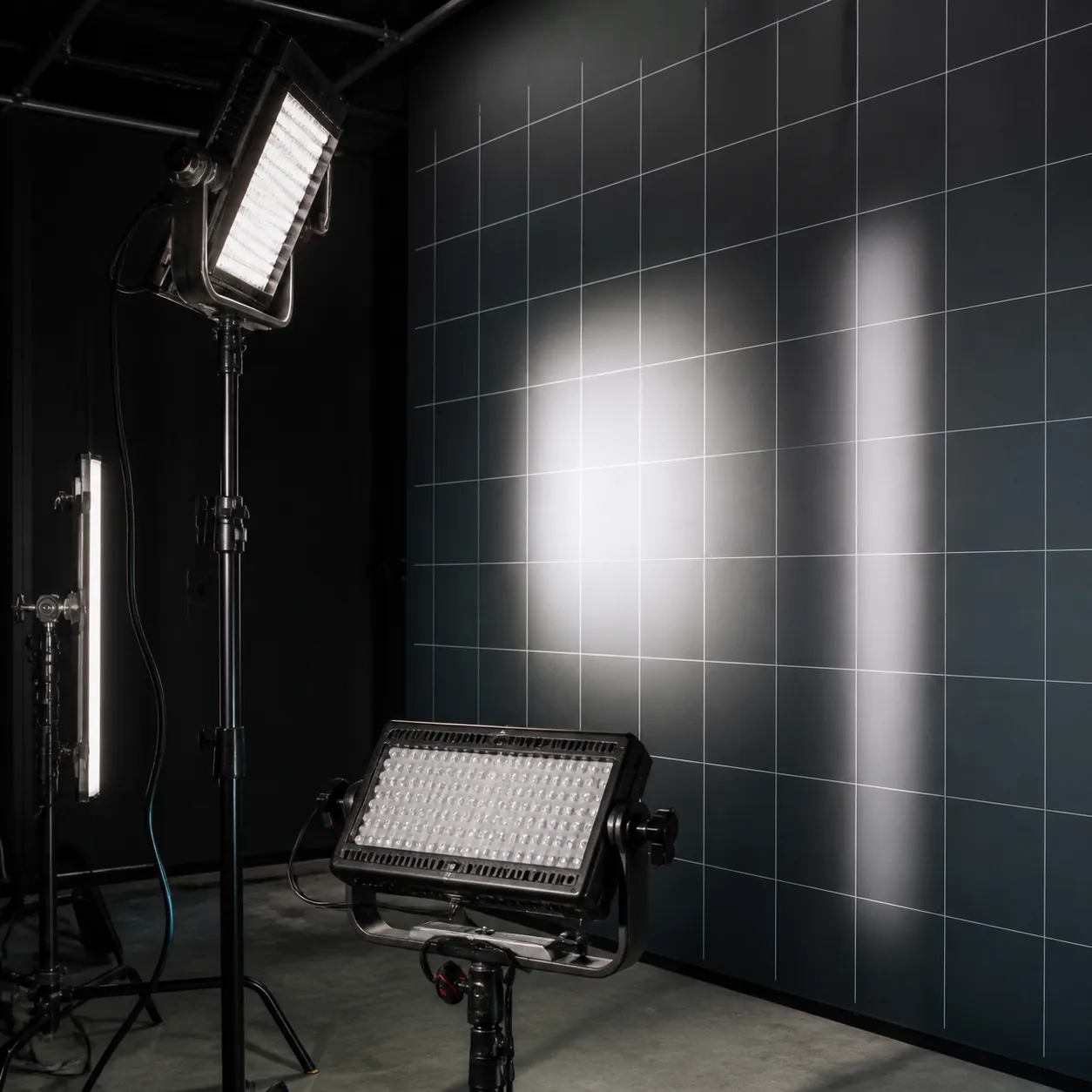 LED fixtures being checked against a dark grid wall in a lighting lab